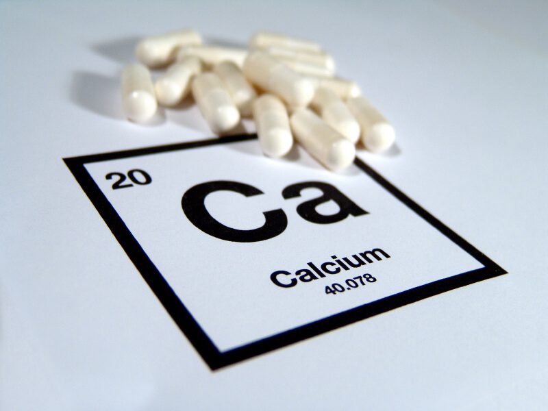 Calcium tablets on a cut out of the Calcium bock from the periodic table